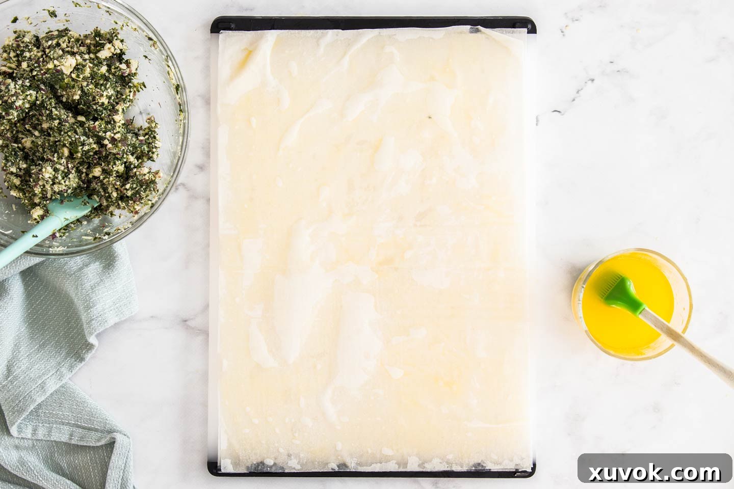 Two sheets of delicate filo pastry stacked, with the bottom layer brushed with melted butter.