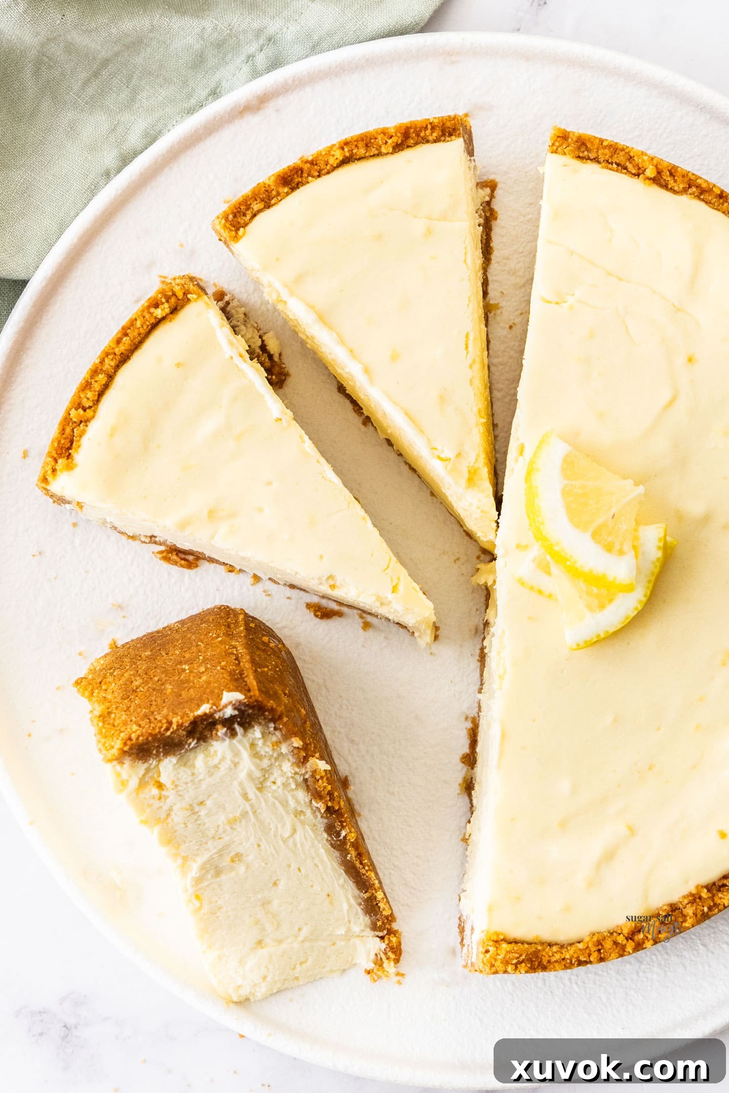 Top down view of the baked lemon cheesecake cut into slices.