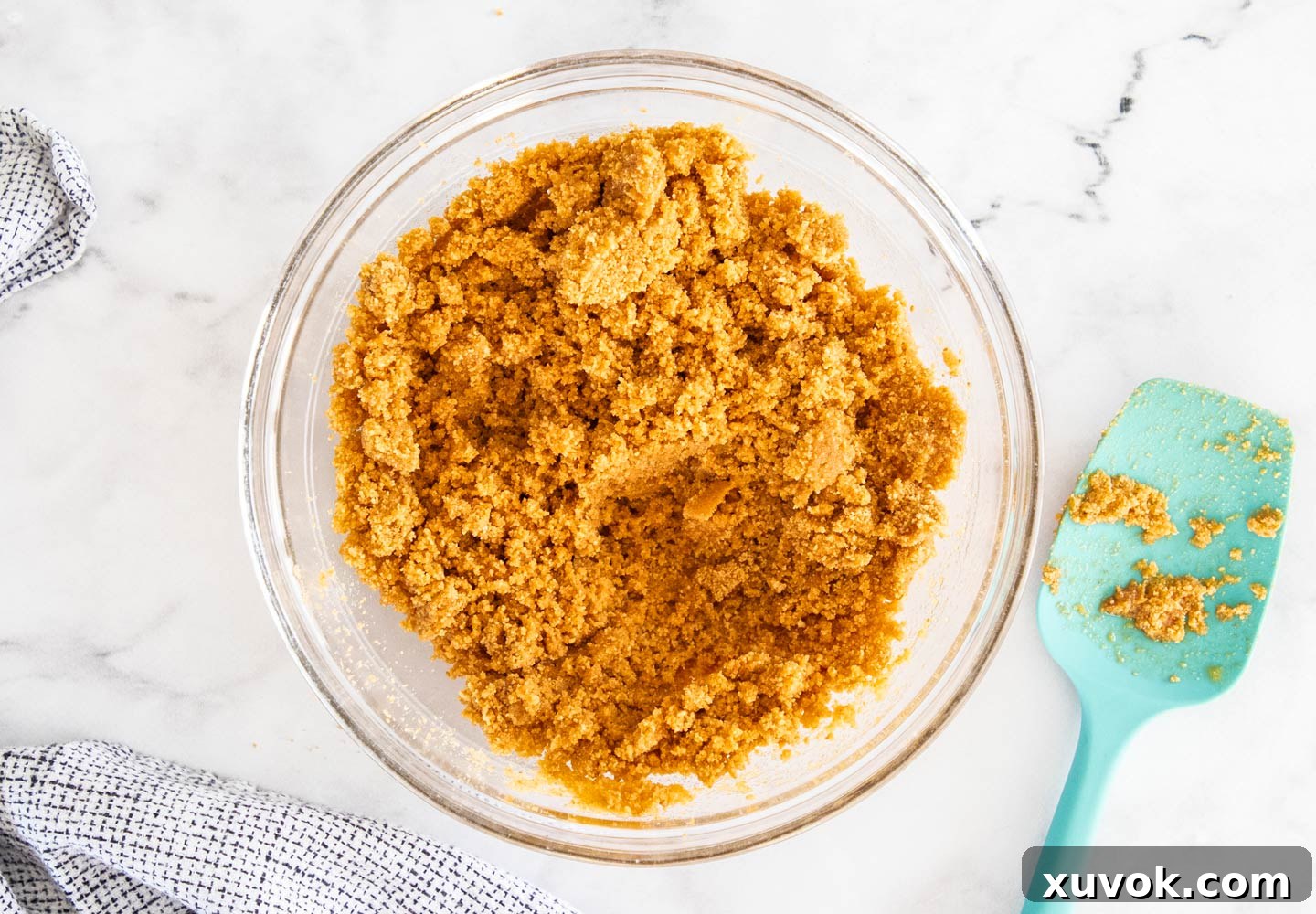 The cookie crumbs mixed with butter in a bowl.