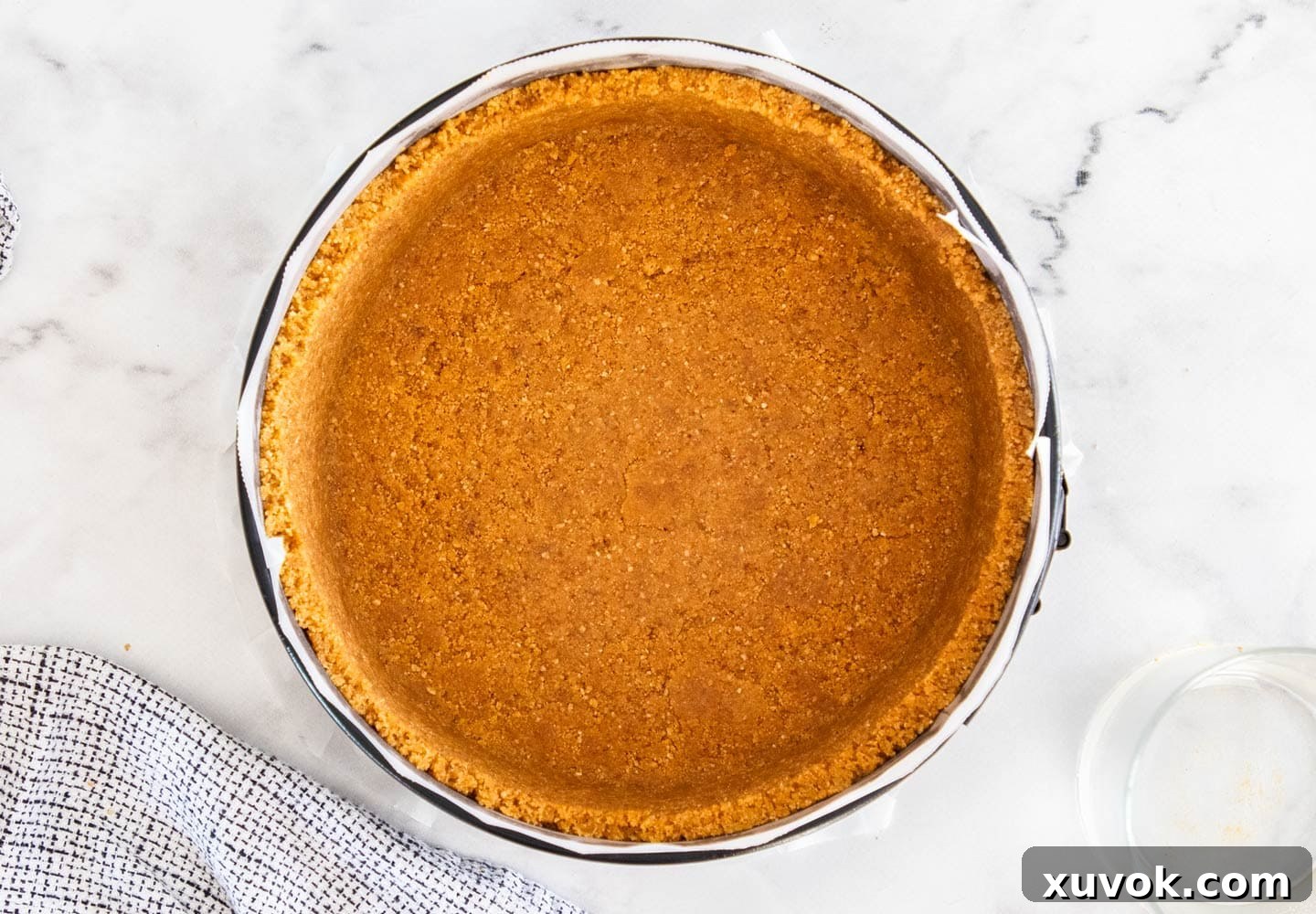 The cookie crumb crust in a springform pan.