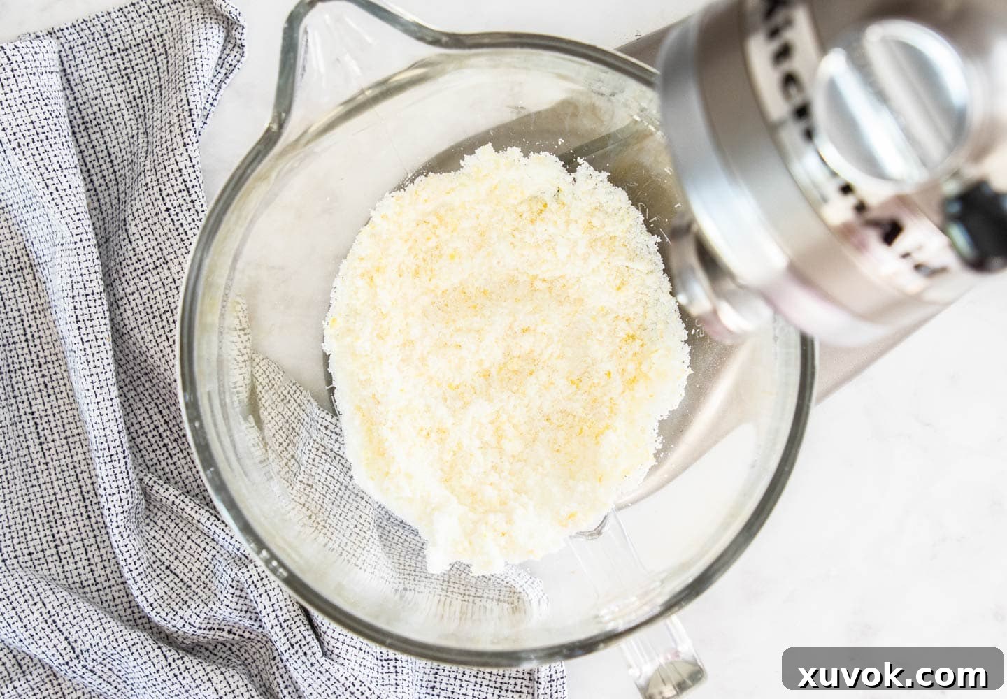 The lemon sugar in the bowl of a stand mixer.