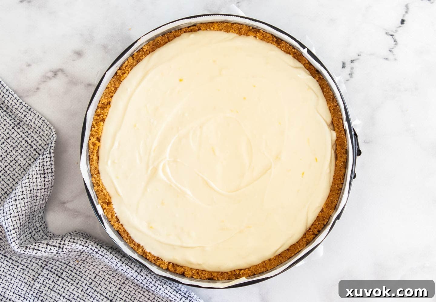 Top down view of the cheesecake batter in the cookie crust.