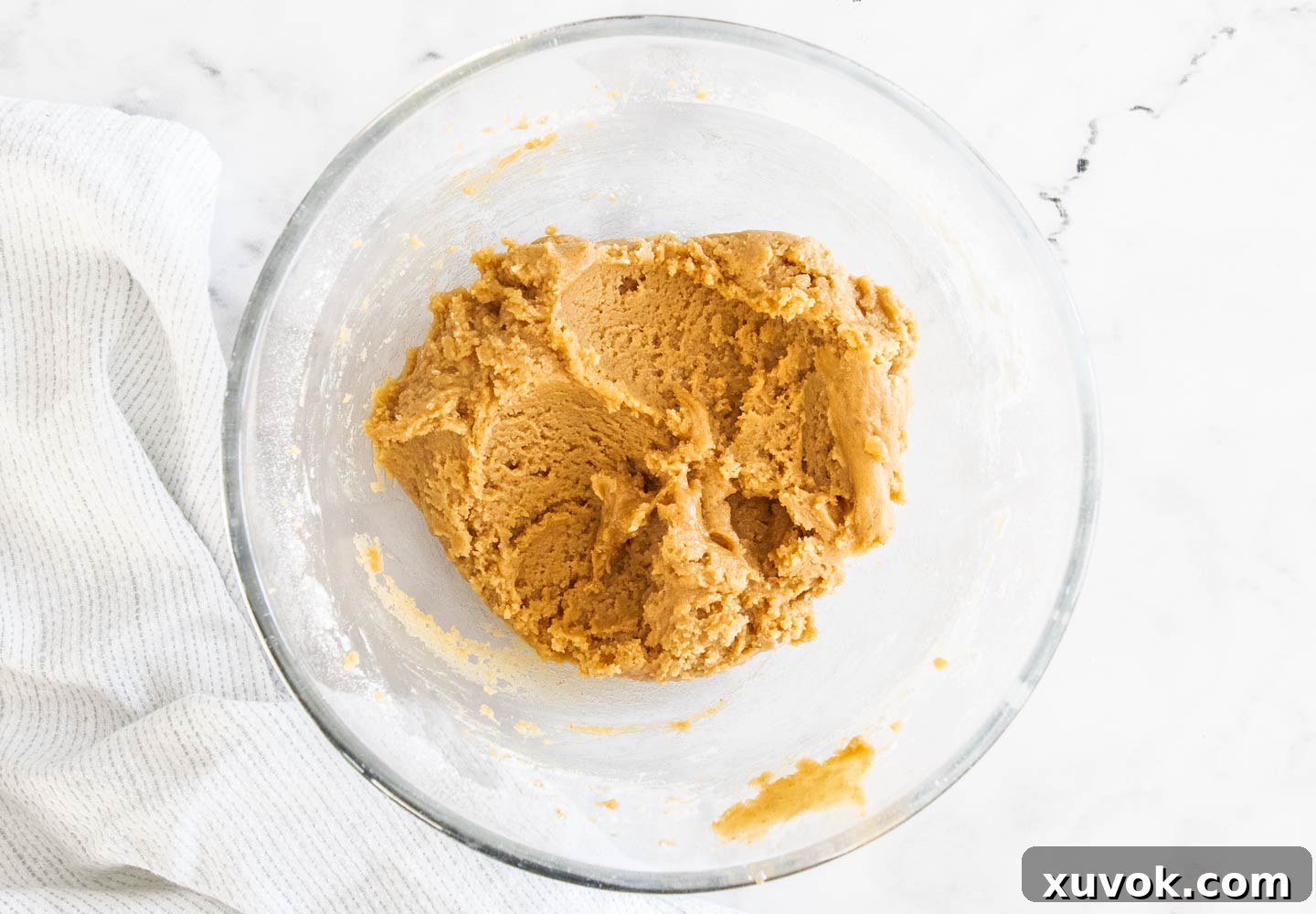A bowl of rich, smooth cookie dough, perfectly mixed and ready to be scooped and baked into delicious treats.