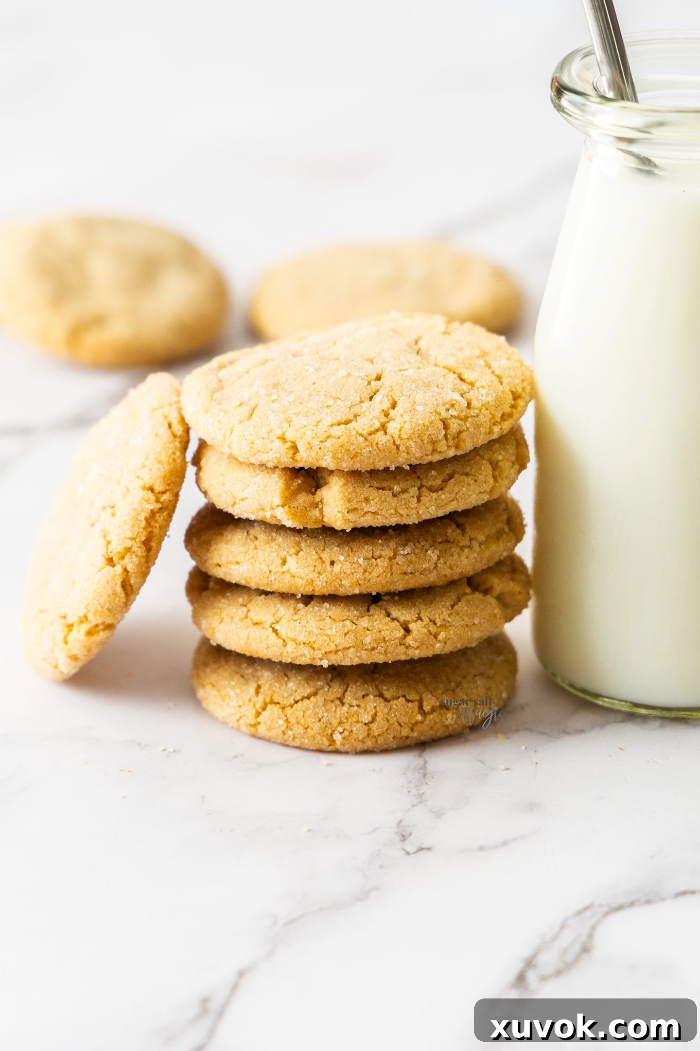 A perfectly stacked pile of five golden-brown browned butter peanut butter cookies, showcasing their inviting texture and deliciousness.