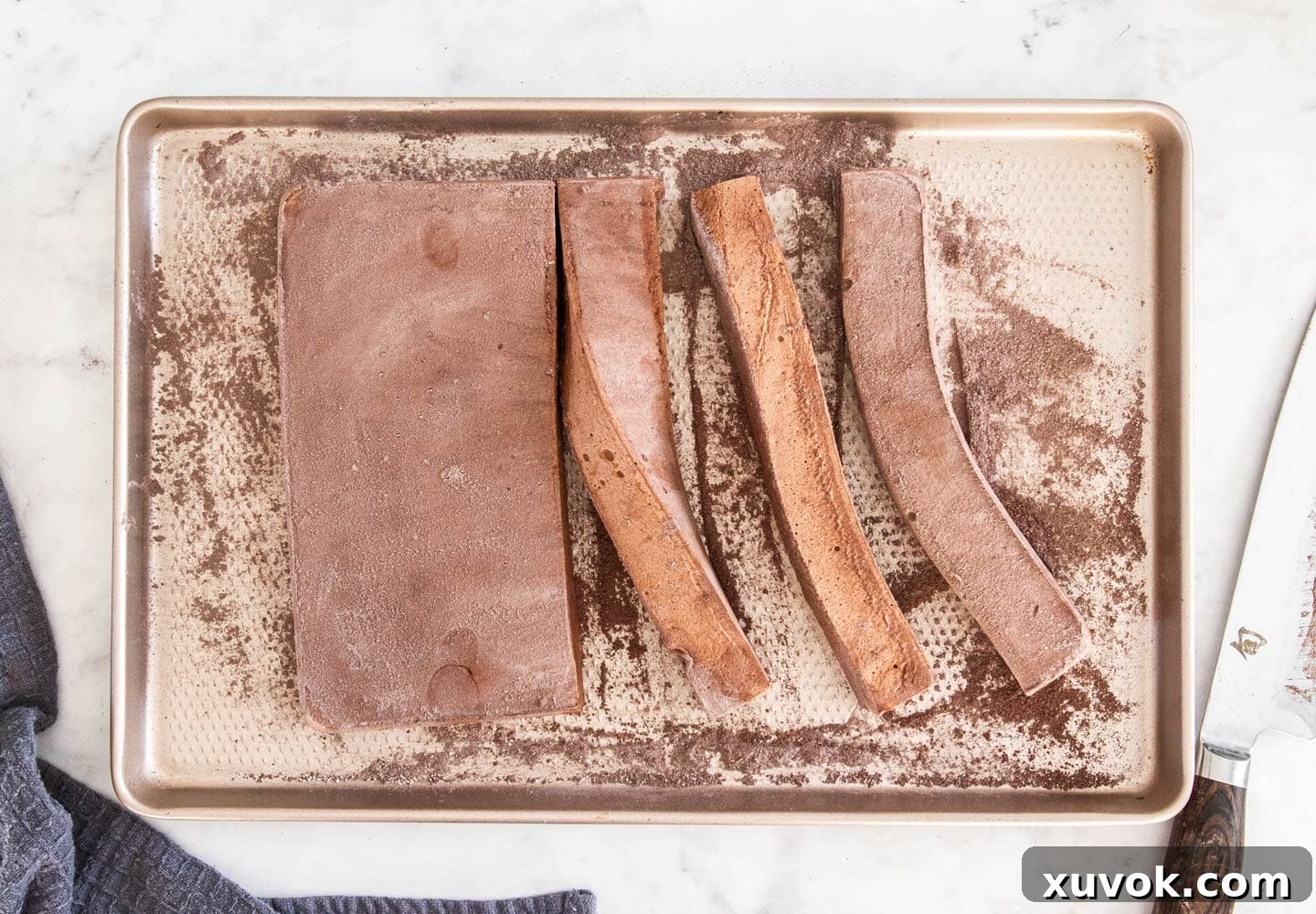 The block of chocolate marshmallow, dusted with cocoa sugar and cut into strips, showcasing its internal texture.