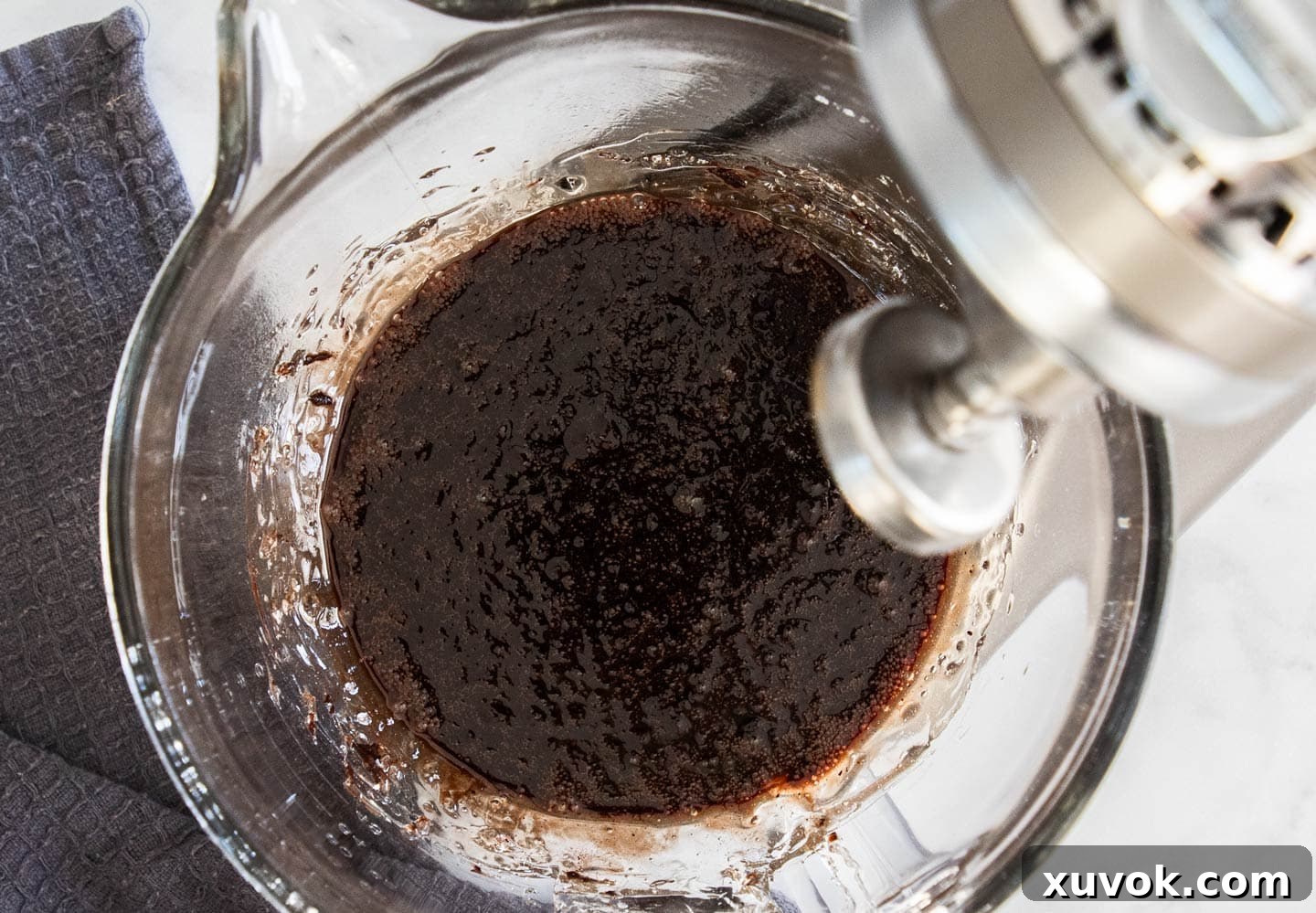 The combined cocoa paste, sugar syrup, and bloomed gelatin in a mixing bowl, ready for whipping into chocolate marshmallows.
