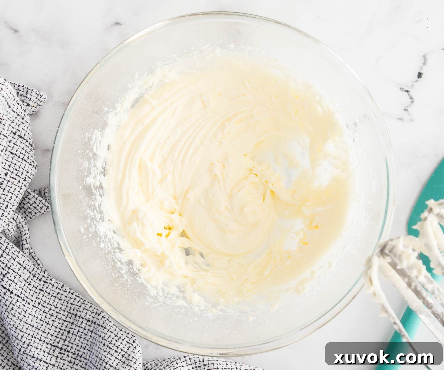 Softened butter, icing sugar, and lemon juice beaten together in a bowl for the frosting.