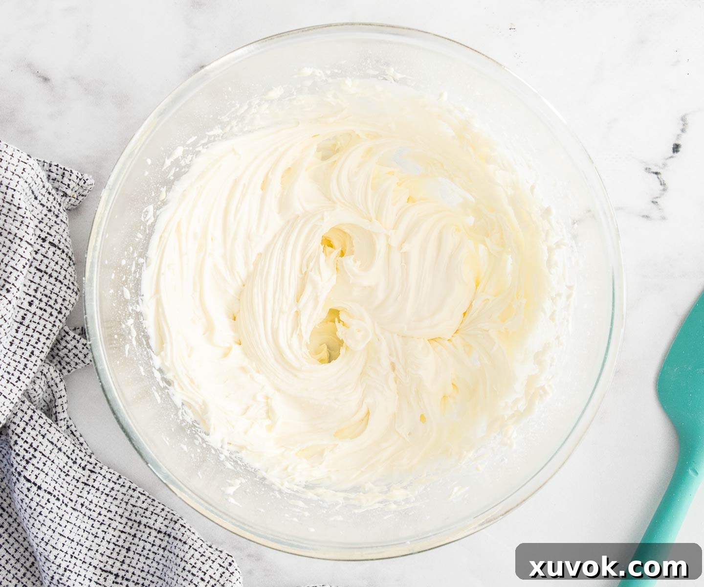 The creamy lemon frosting, after white chocolate has been added and beaten in, showing its smooth texture.