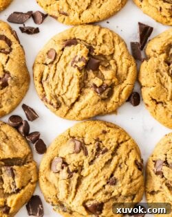 Top down view of a batch of ultimate chocolate chip cookies lined up, showcasing their perfect bake and generous chocolate chunks.