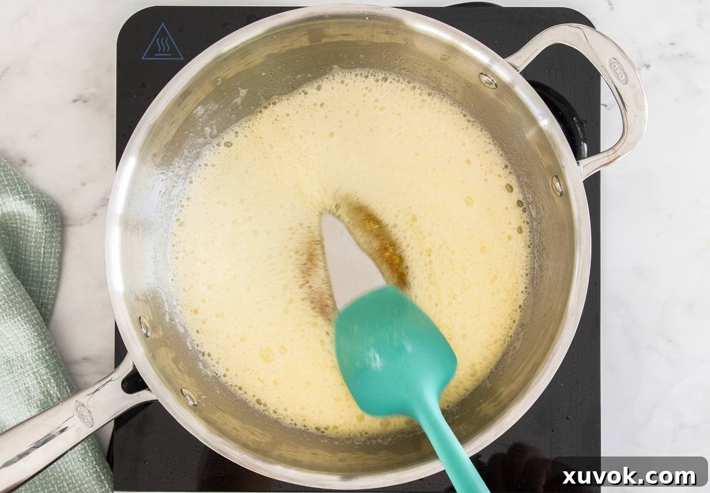 Browned butter simmering gently in a pan, showcasing its rich amber color.
