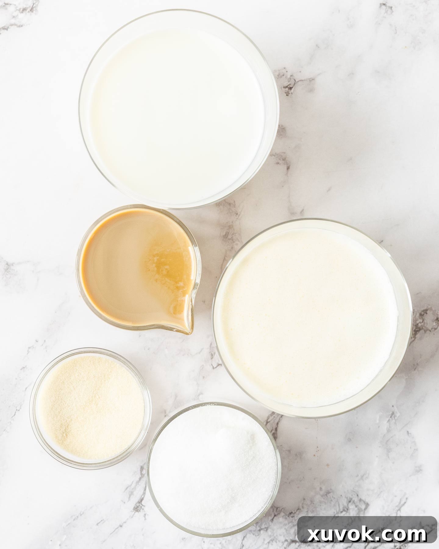 Ingredients for Baileys panna cotta on a marble surface.