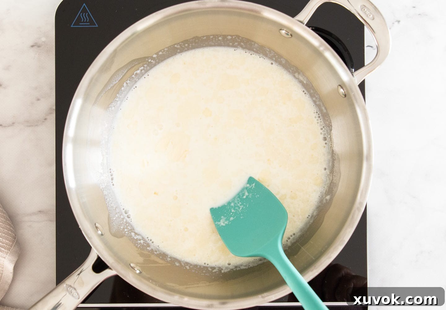 Stirring the gelatine into the milk.
