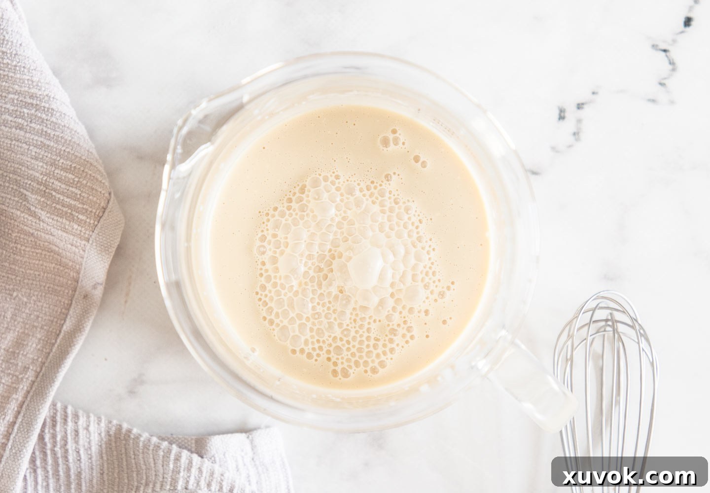 The Baileys panna cotta mixture in a glass jug.