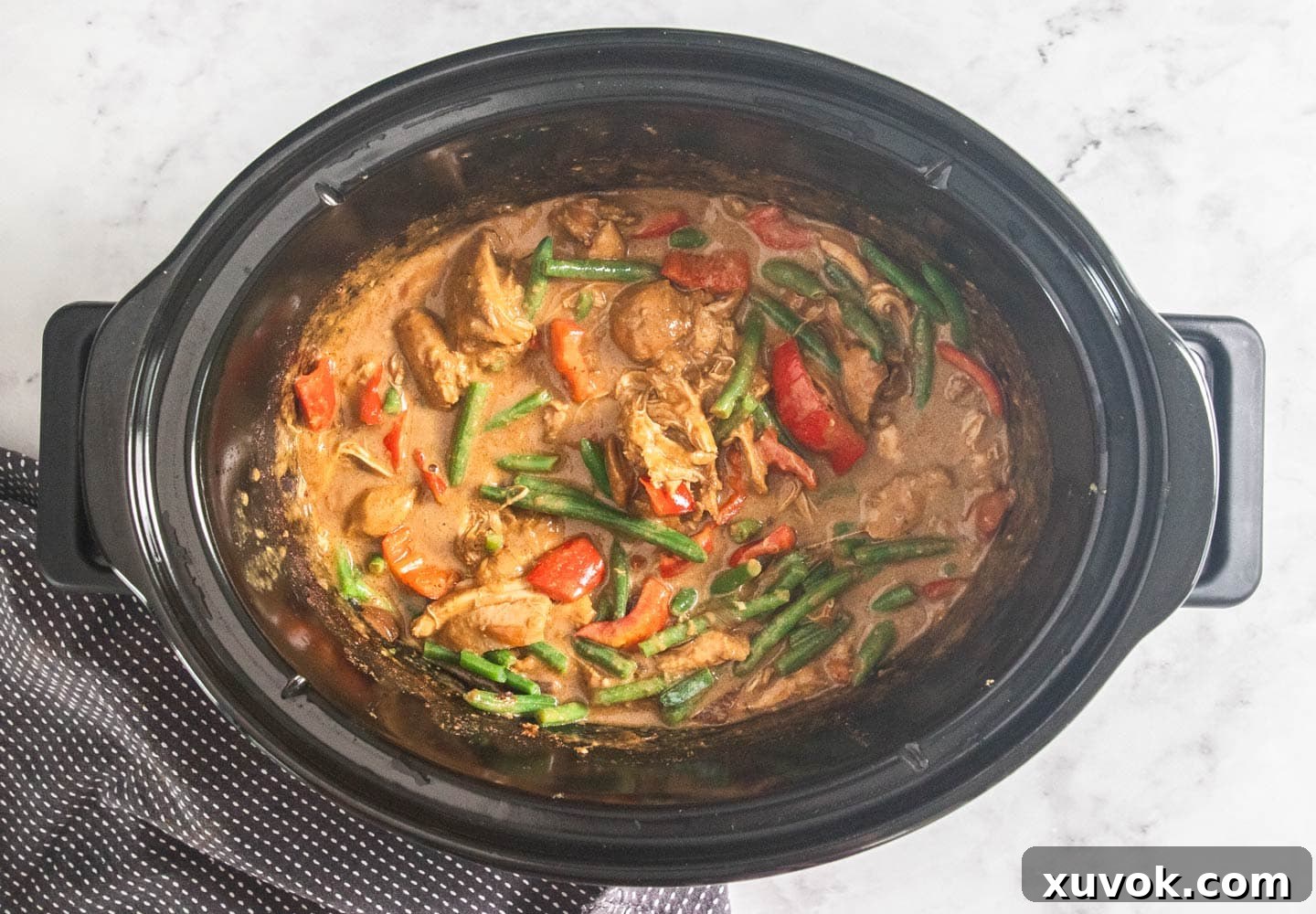 Slow cooker satay chicken in a slow cooker.