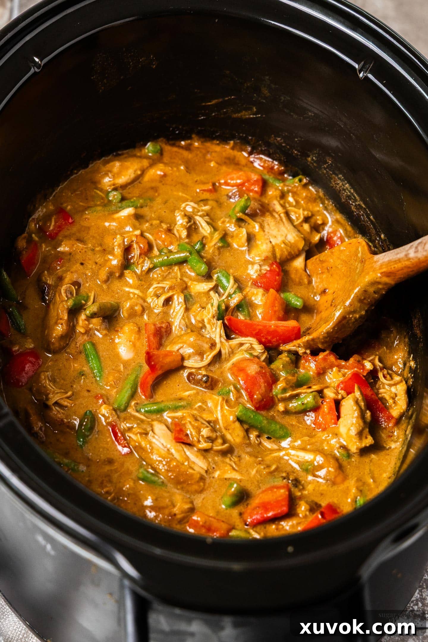 Slow cooker satay chicken in a slow cooker.