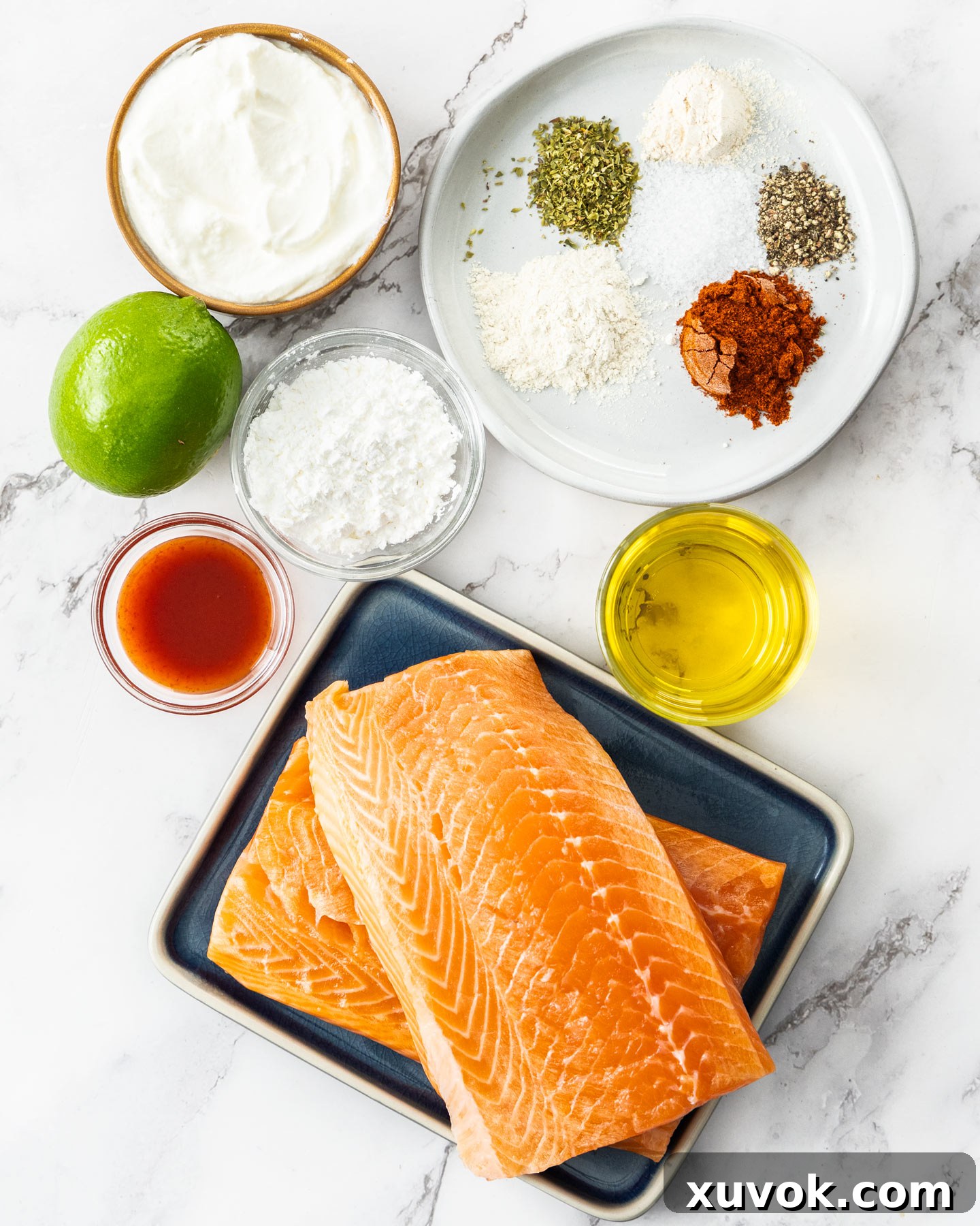 Ingredients for crispy salmon bites on a marble surface.