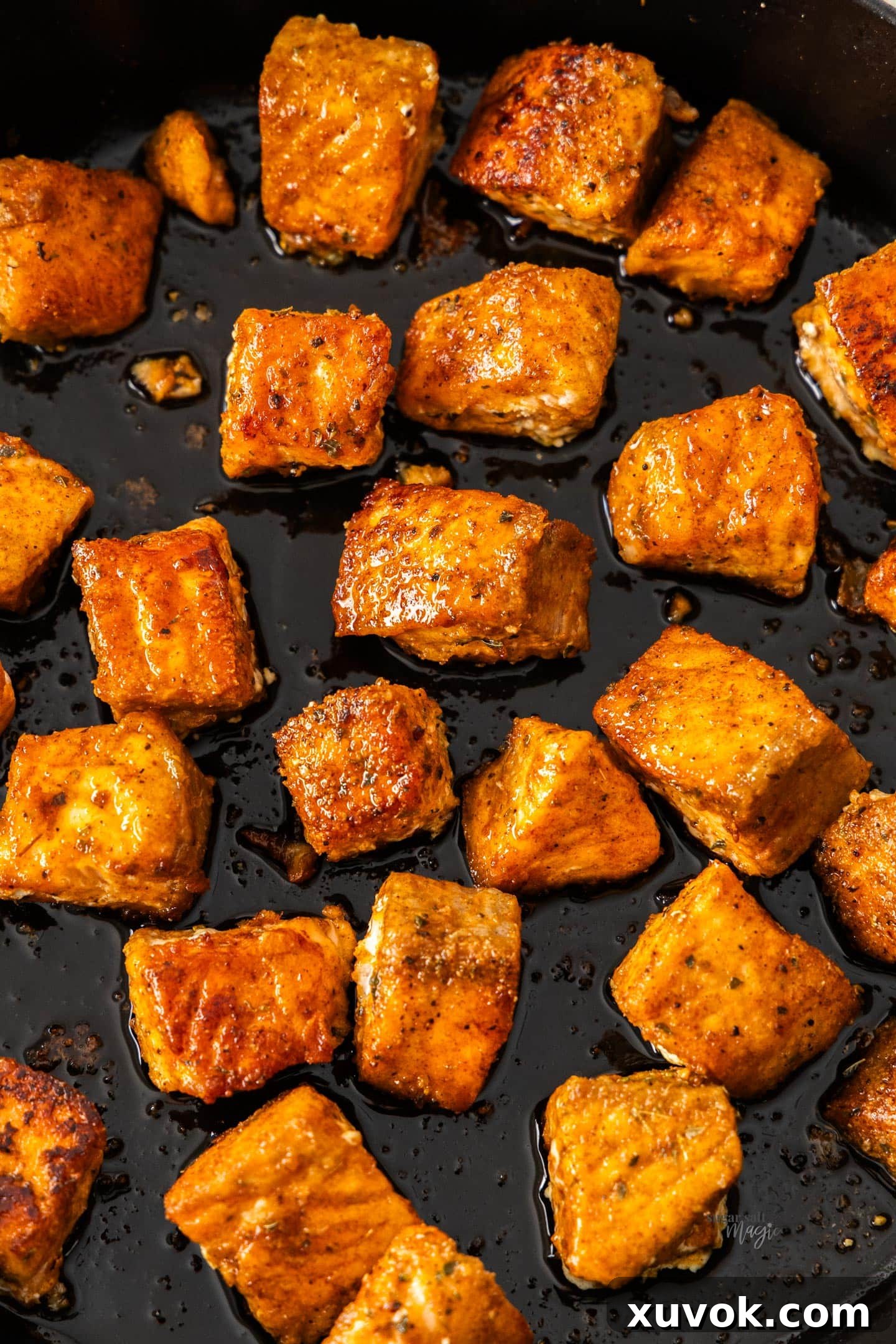Crispy salmon bites in a pan, ready to serve.