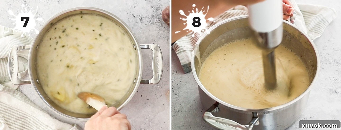 Potato chowder being blended in a large pot using an immersion blender for a smooth consistency.