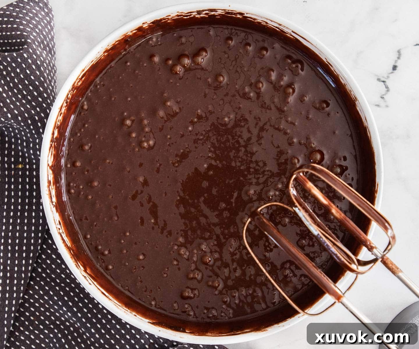 The dark, smooth chocolate cake batter in a mixing bowl after wet ingredients have been incorporated.