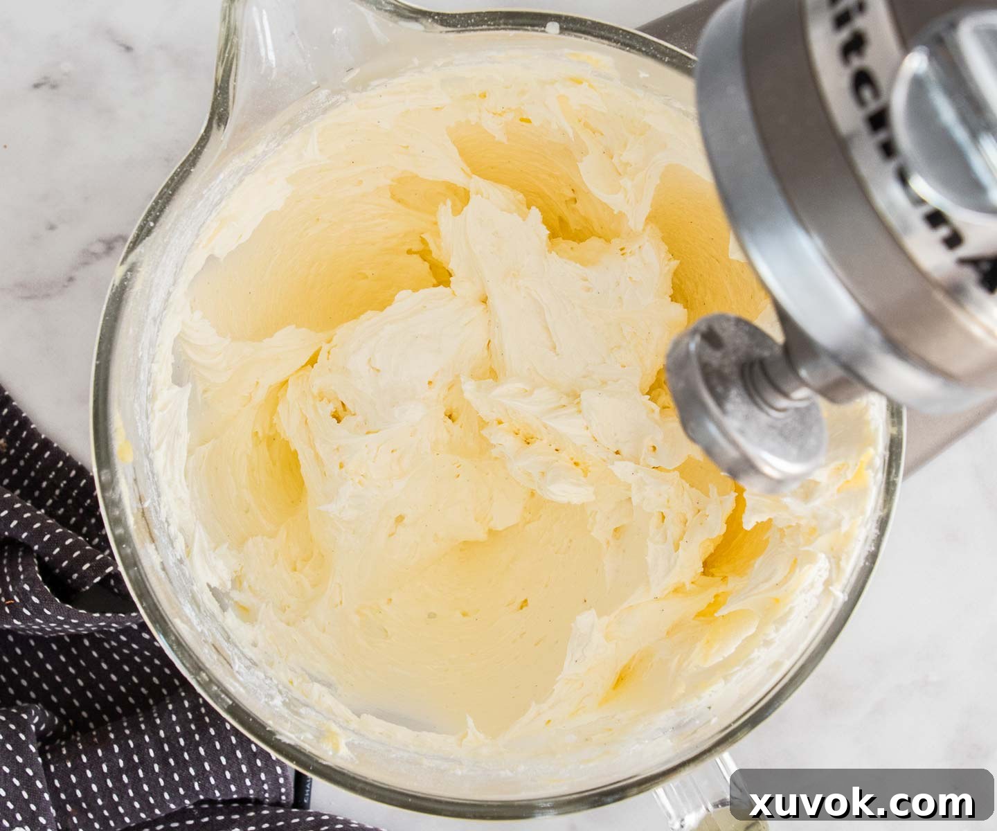 The fully whipped vanilla buttercream in the stand mixer, looking light, fluffy, and ready for spreading.