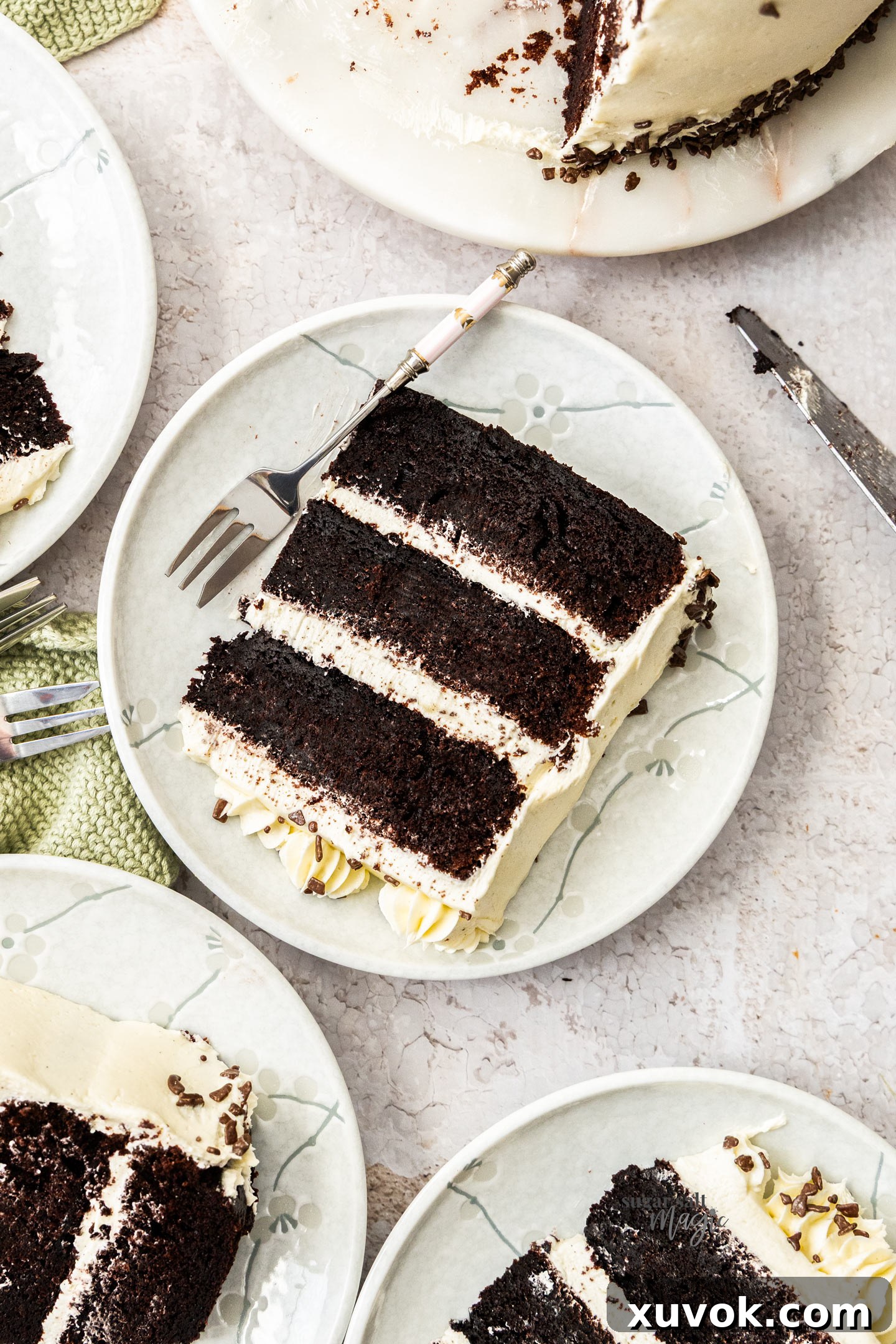 Beautifully cut slices of black and white cake, showing the contrasting layers of fudgy chocolate cake and creamy vanilla buttercream, arranged on dessert plates.