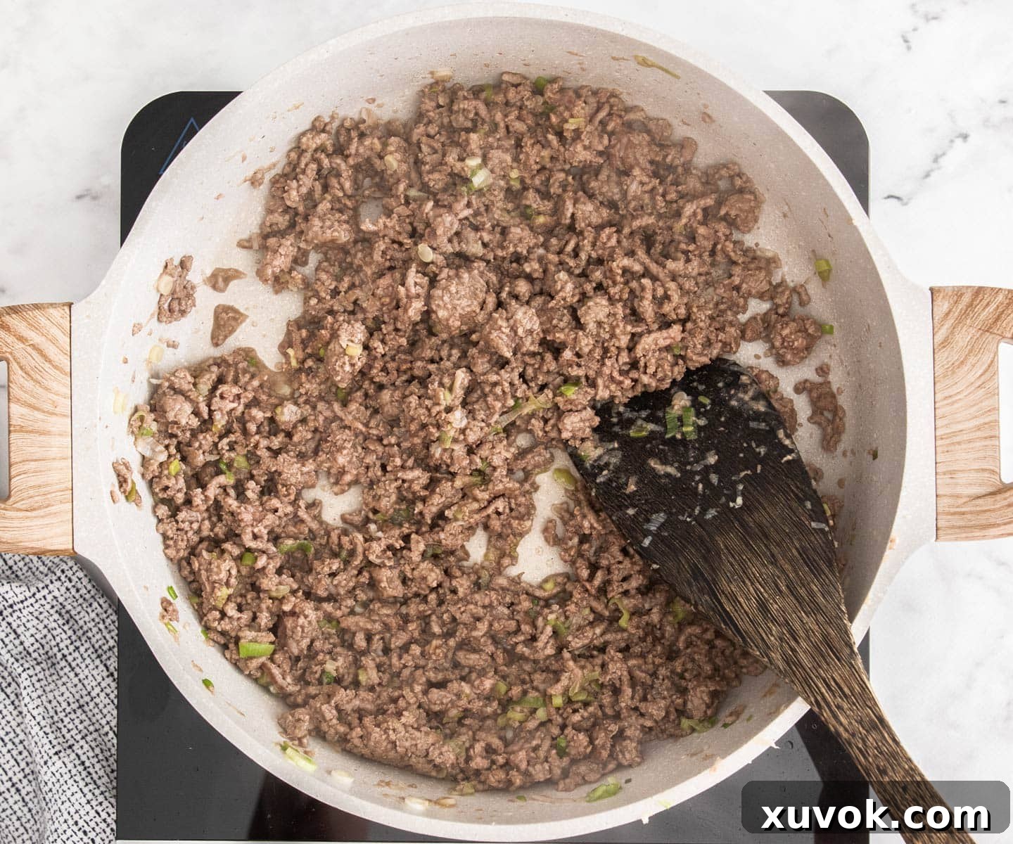 The beef being browned in the pan.