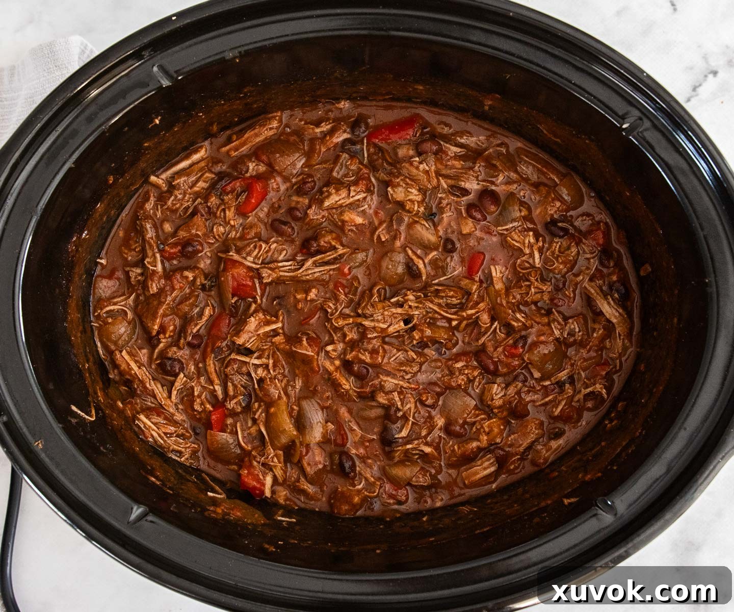The finished chilli con carne in the bowl of a slow cooker, thick and ready to be served.