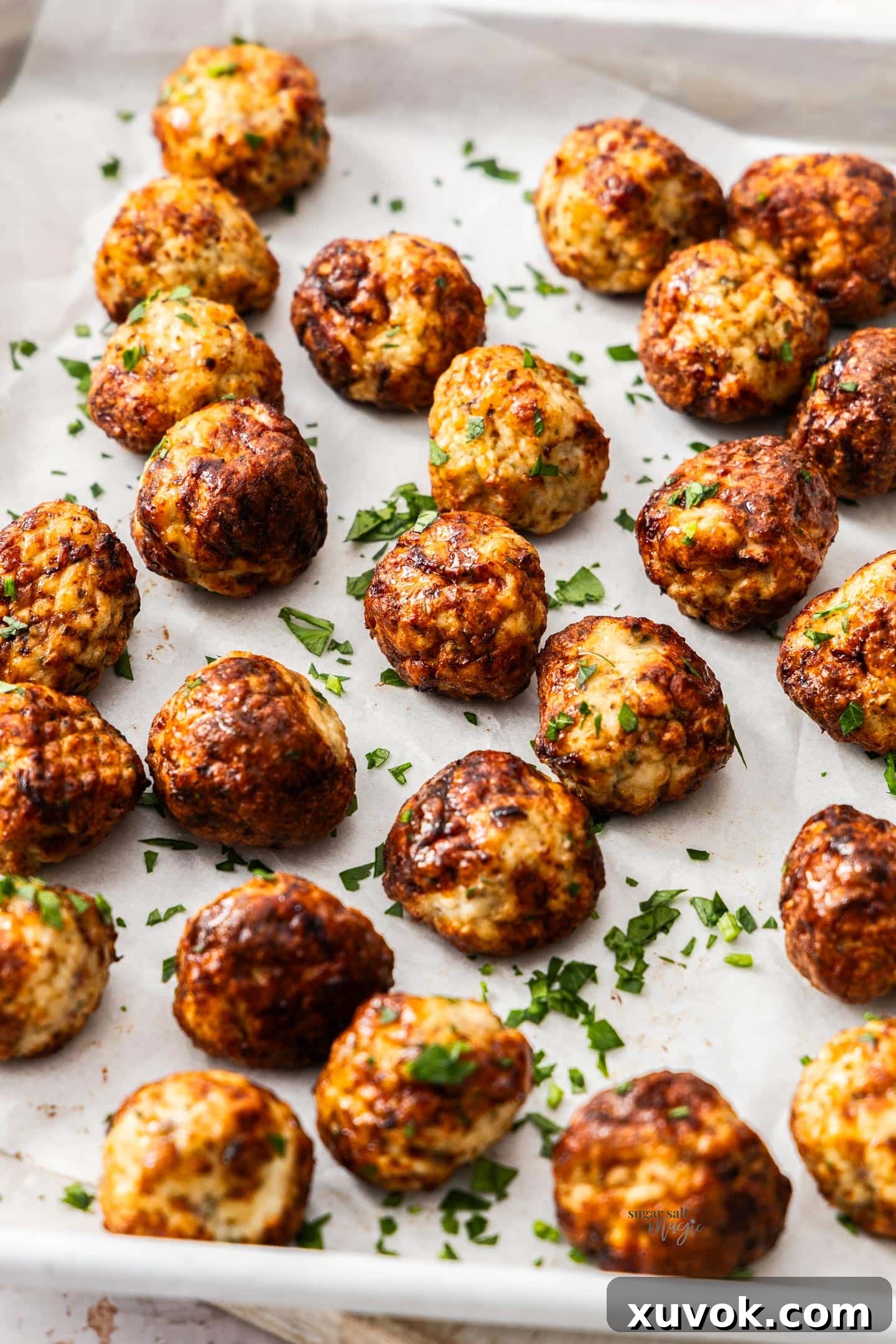 A tray of air fried chicken meatballs on a white surface.