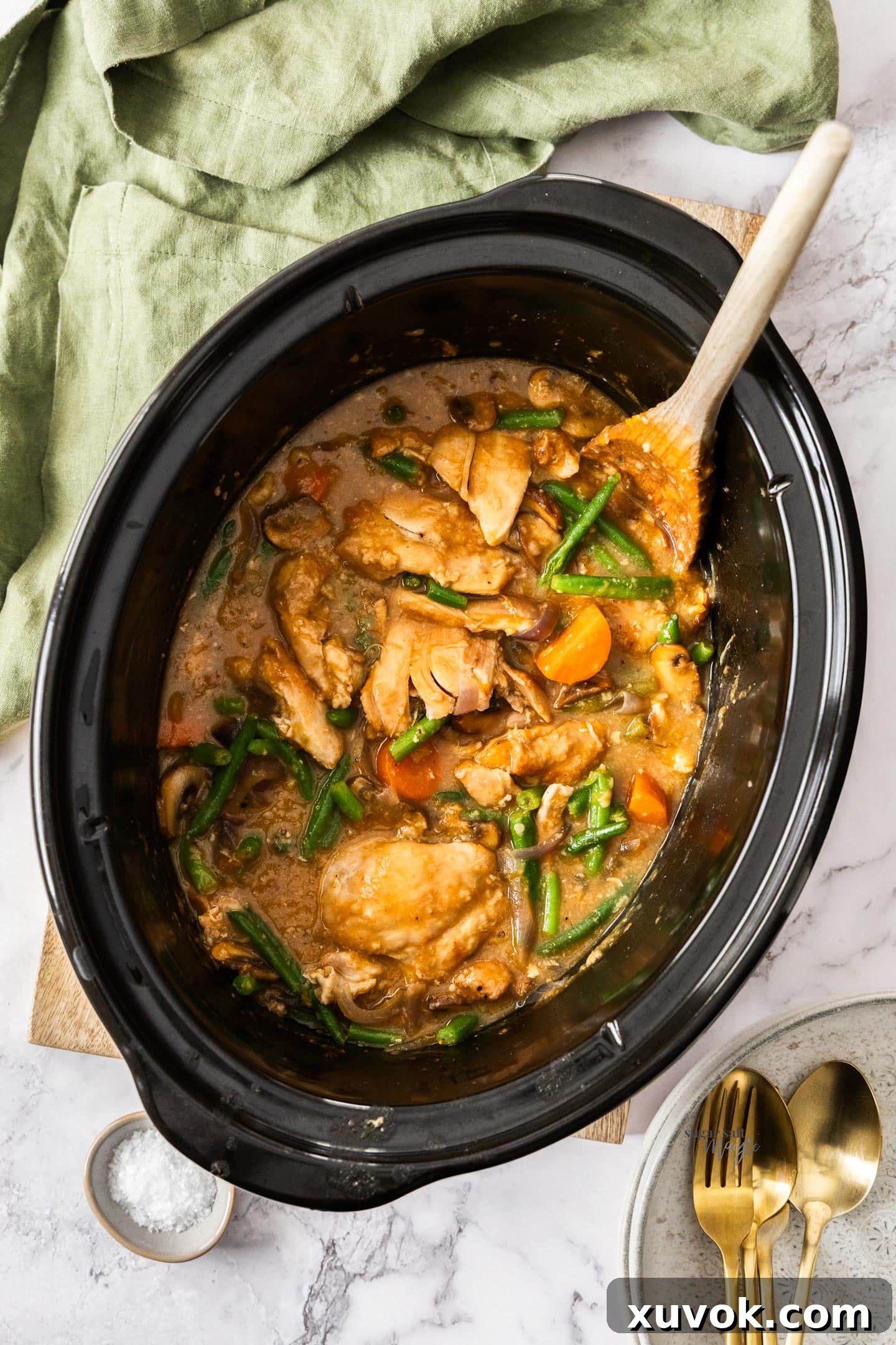 Top down view of slow cooker apricot chicken in a slow cooker bowl, ready to be served.