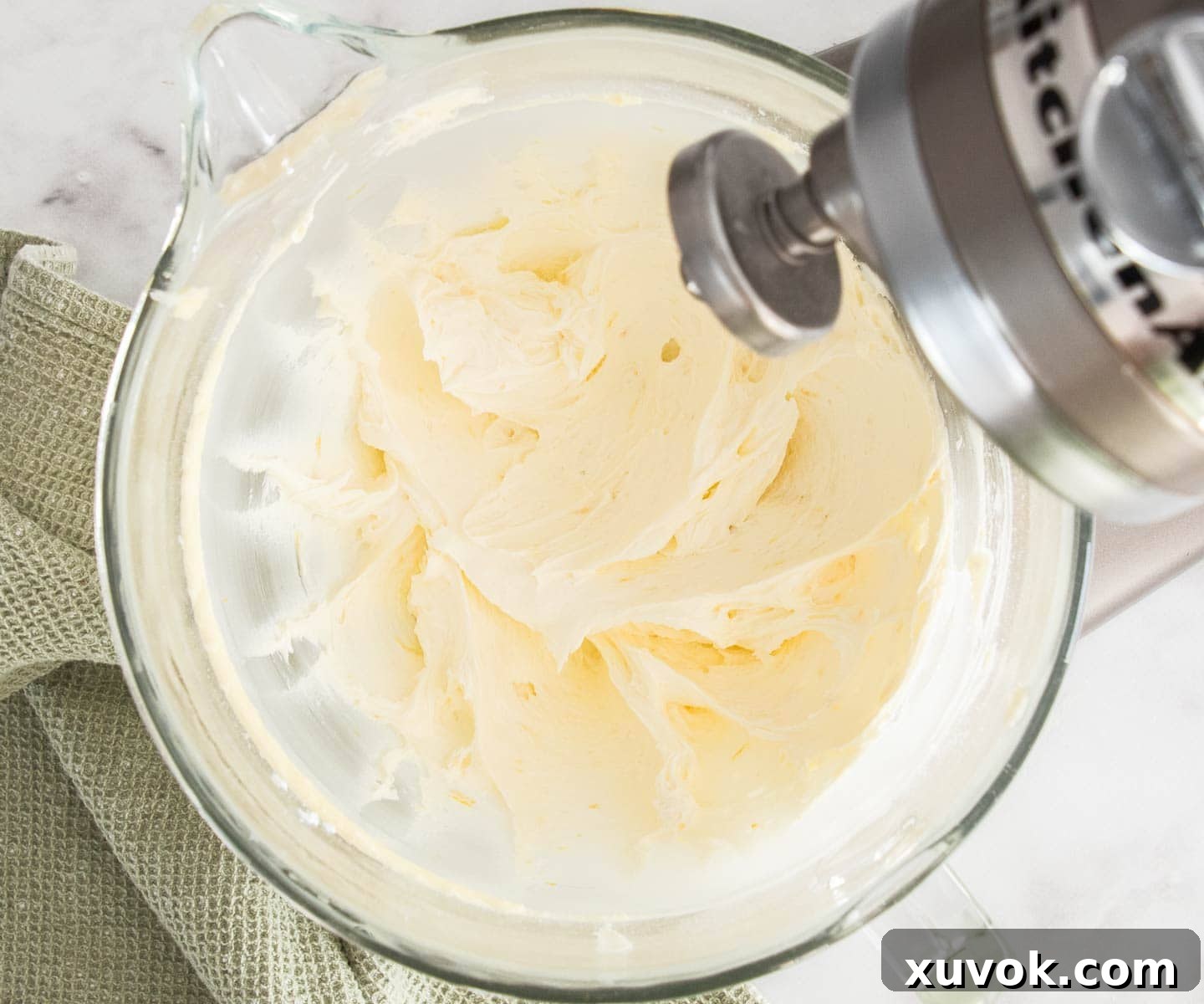 Vanilla buttercream beaten to a light and fluffy consistency in a mixing bowl.