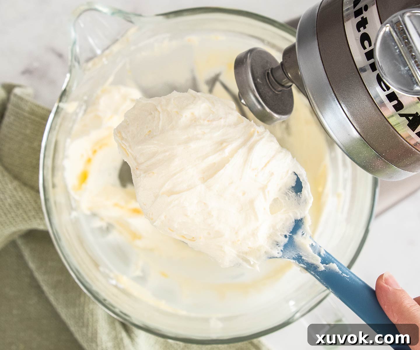 The creamy buttercream filling on a spatula, showing its perfect consistency.