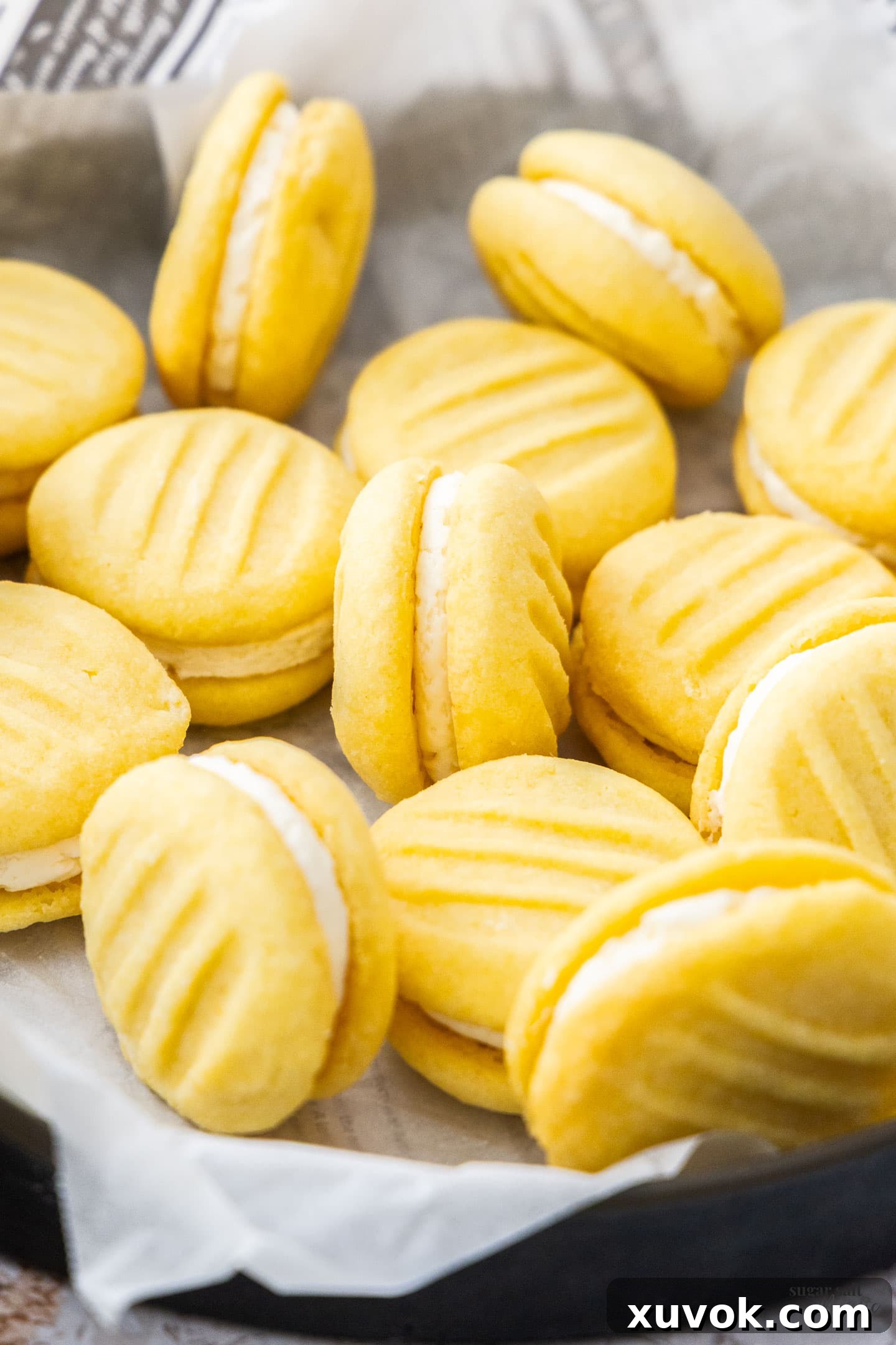 A batch of golden Yo Yo Biscuits arranged neatly in a vintage metal tray, ready to be enjoyed.