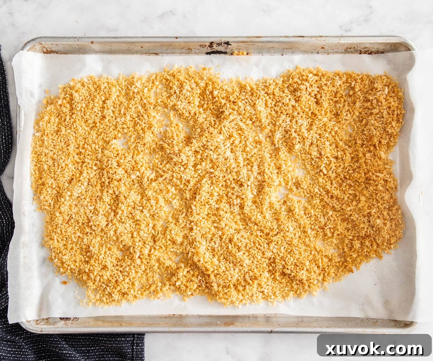 Golden baked breadcrumbs on a baking sheet.