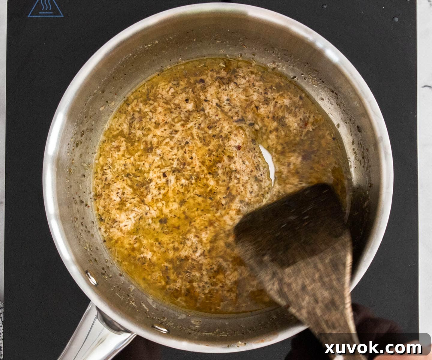 The vibrant lemon juice and savory parmesan cheese being added to the rich butter mixture.