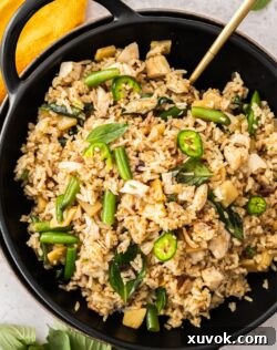 Top down view of Thai fried rice topped with slices of green chilli.
