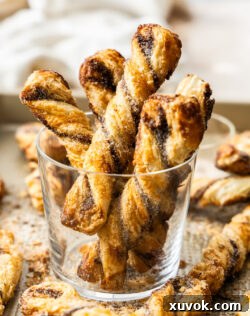 Five cinnamon puff pastry twists in a glass, ready to be served.