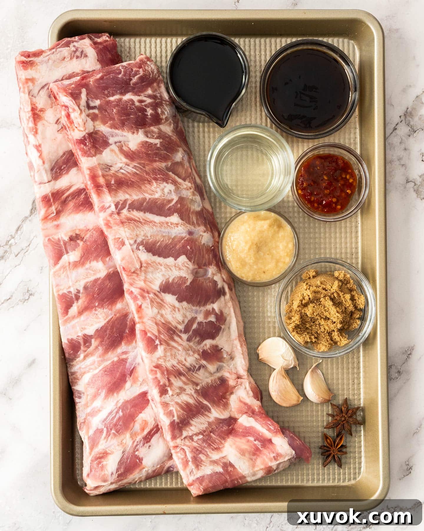 Ingredients for sticky asian ribs laid out on a baking tray.
