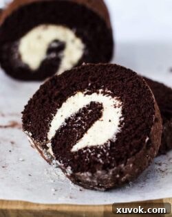 A light Chocolate Swiss Roll Cake filled with a whipped vanilla buttercream frosting is just the perfect afternoon tea treat or dessert. Get my tips on how to make the perfect roll cake.