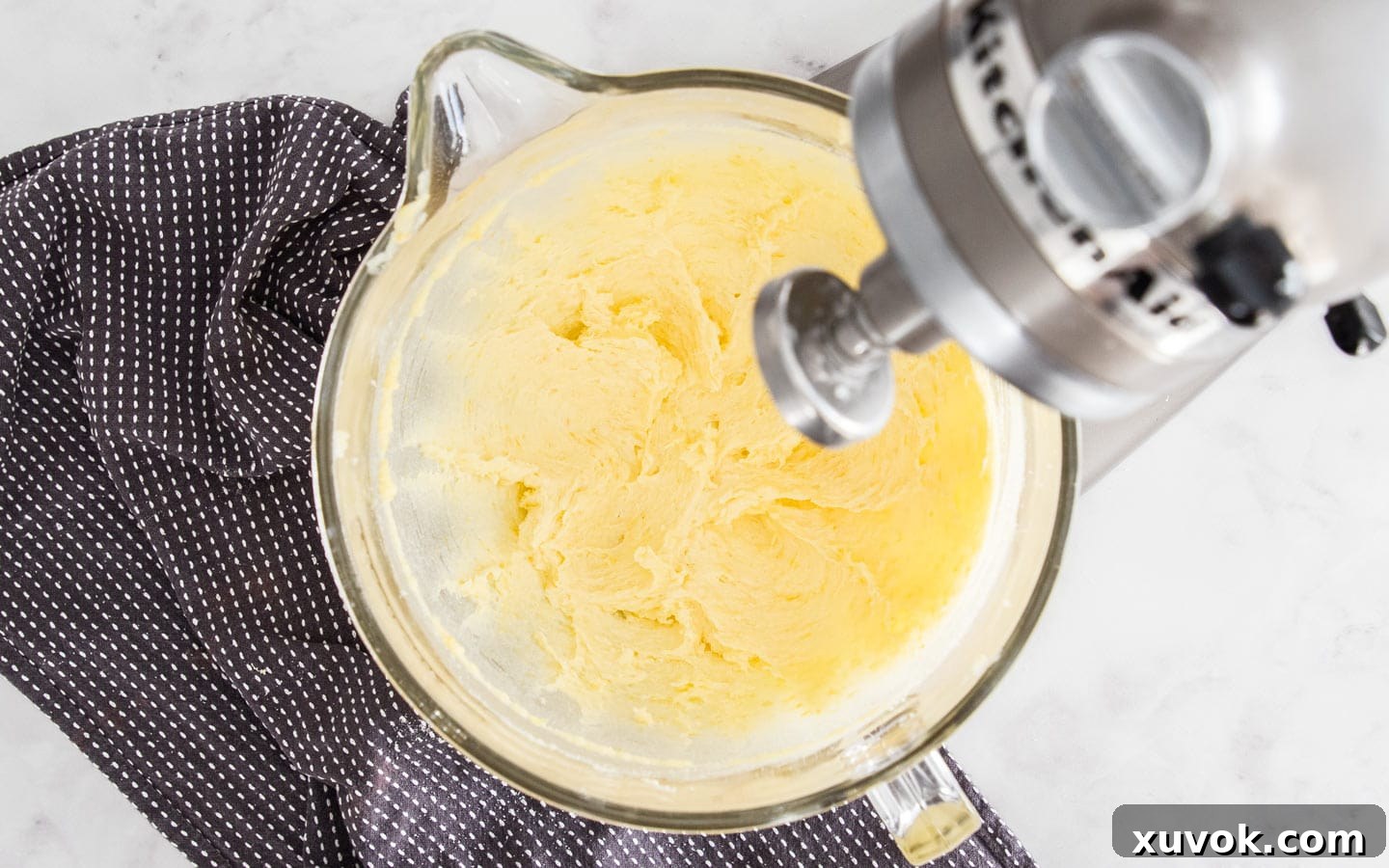 Creamed butter and sugar in a stand mixer bowl, illustrating the light and fluffy texture before adding other ingredients.