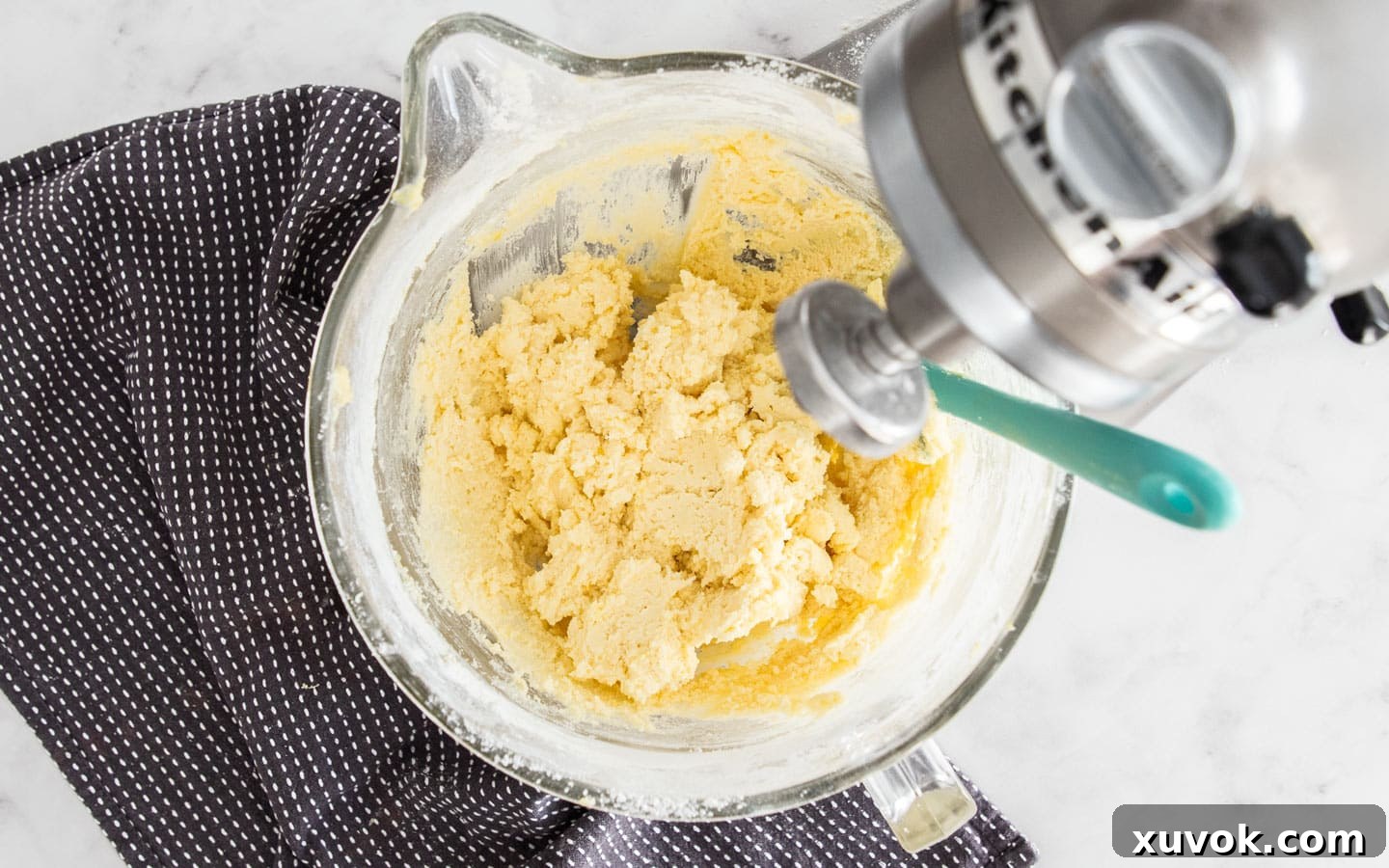 The cookie dough in a mixing bowl after all dry ingredients have been added, showing a cohesive and soft texture.