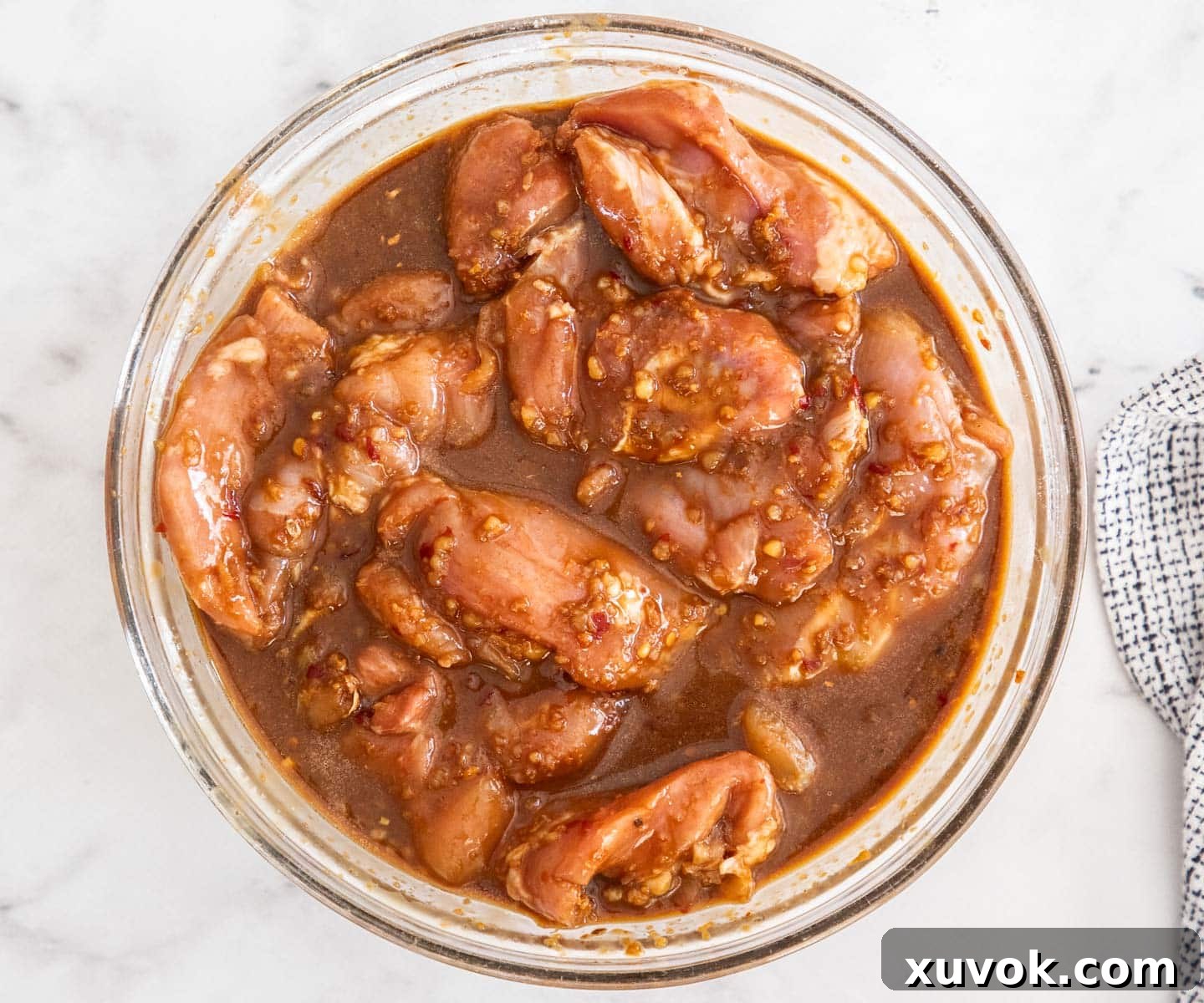 The chicken thighs in the marinade.