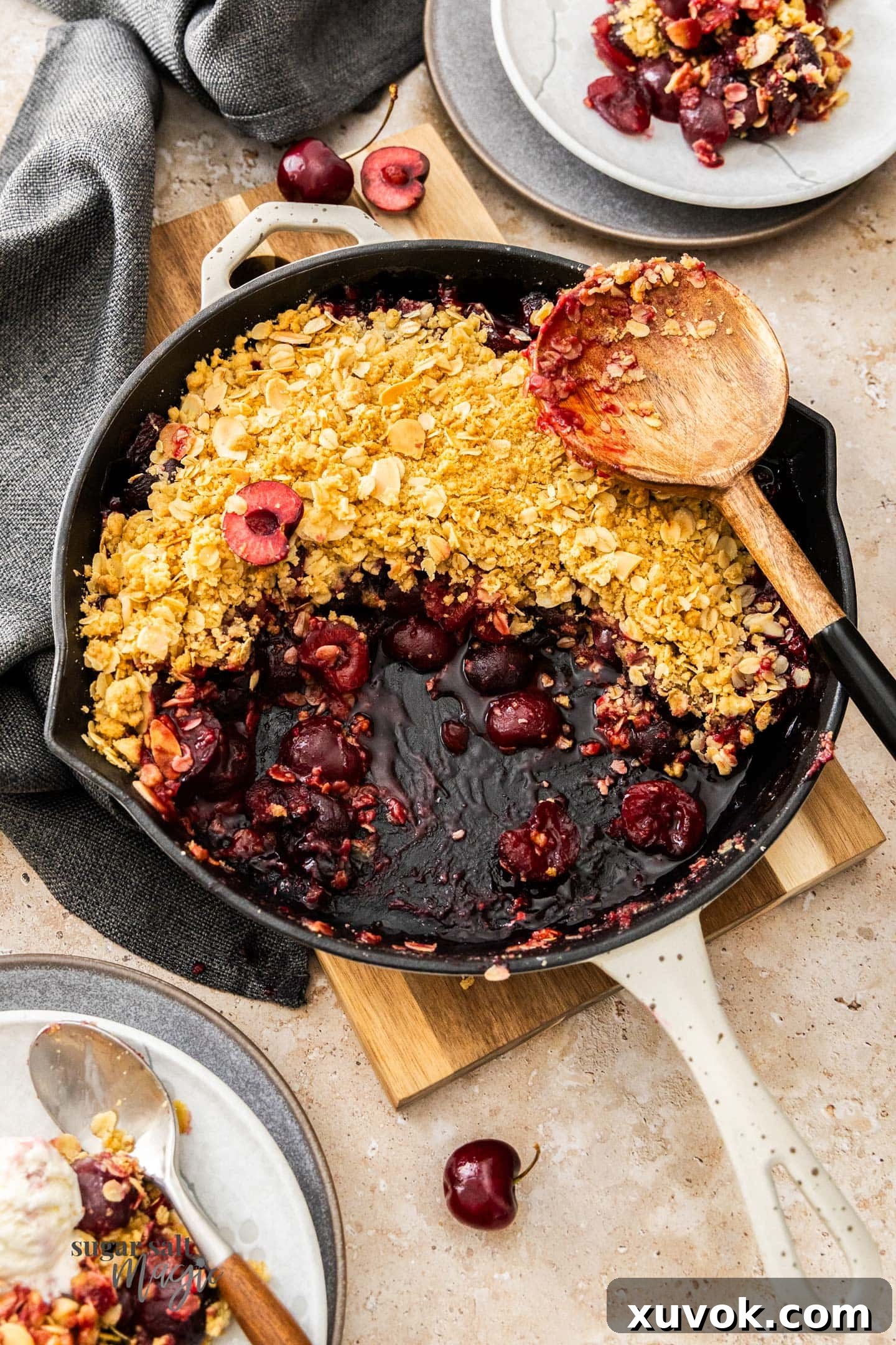 Top down view of baked cherry crumble in a skillet.