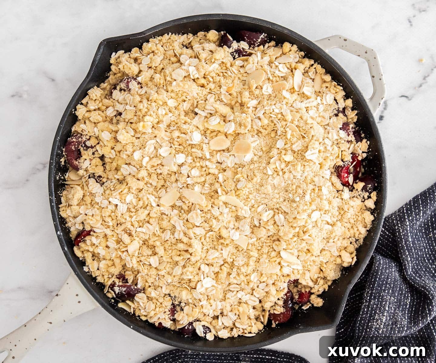 The crumble topping on the cherries, ready to bake.