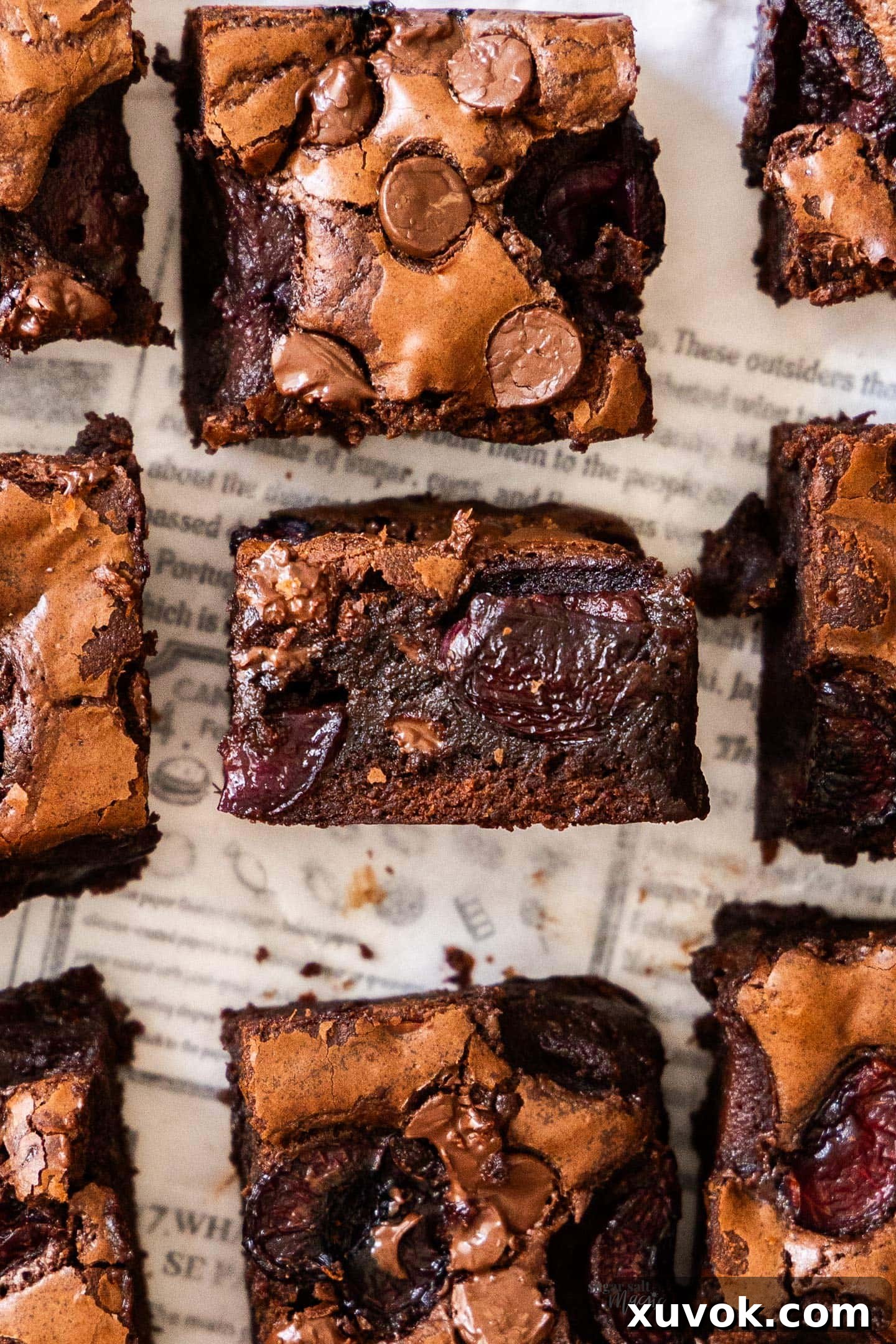 Top down view of 9 brownies with the middle standing up to show the inside texture. Rich, fudgy cherry brownies are ready to be enjoyed.