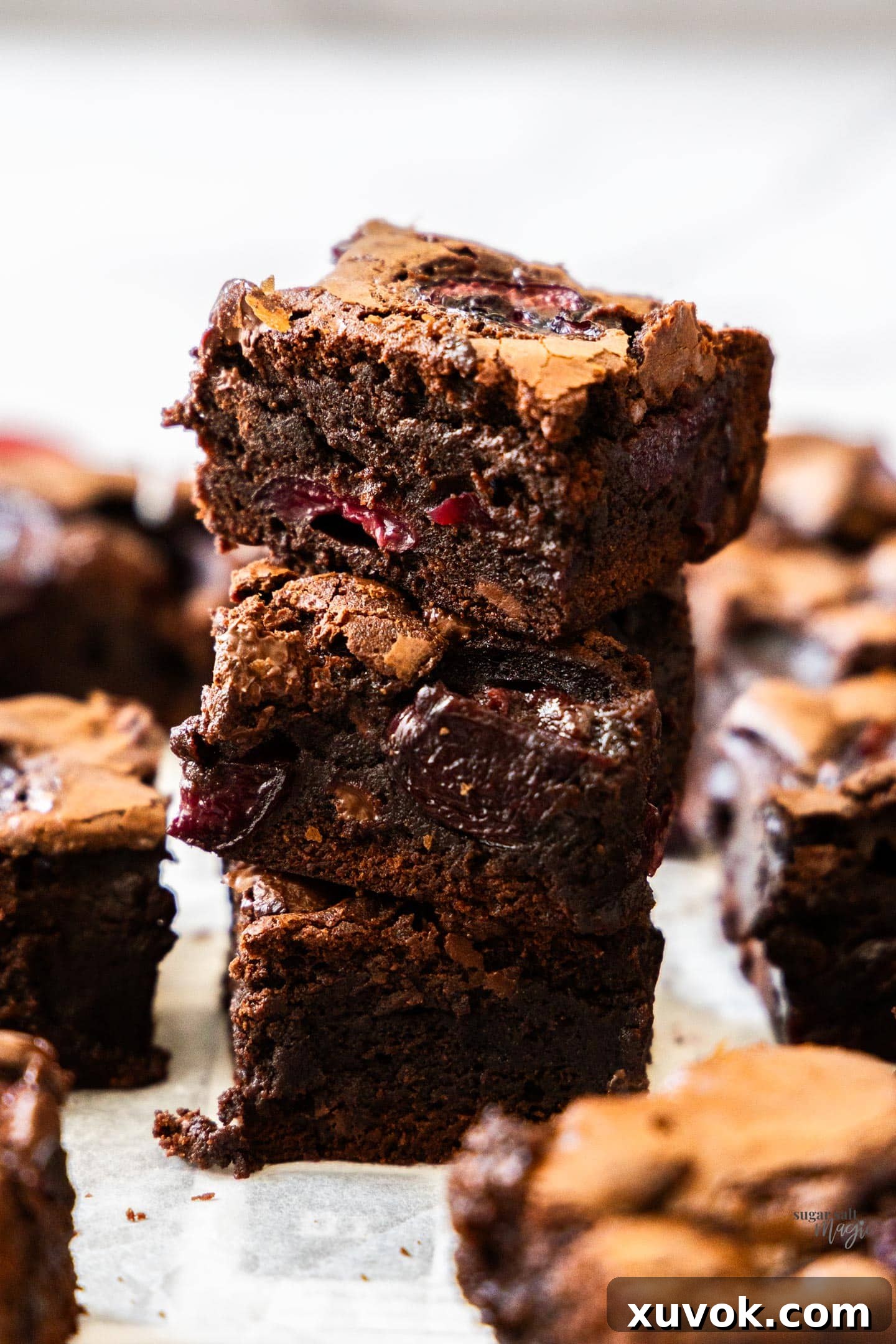 A stack of 3 rich, fudgy cherry brownies, showcasing their decadent texture.