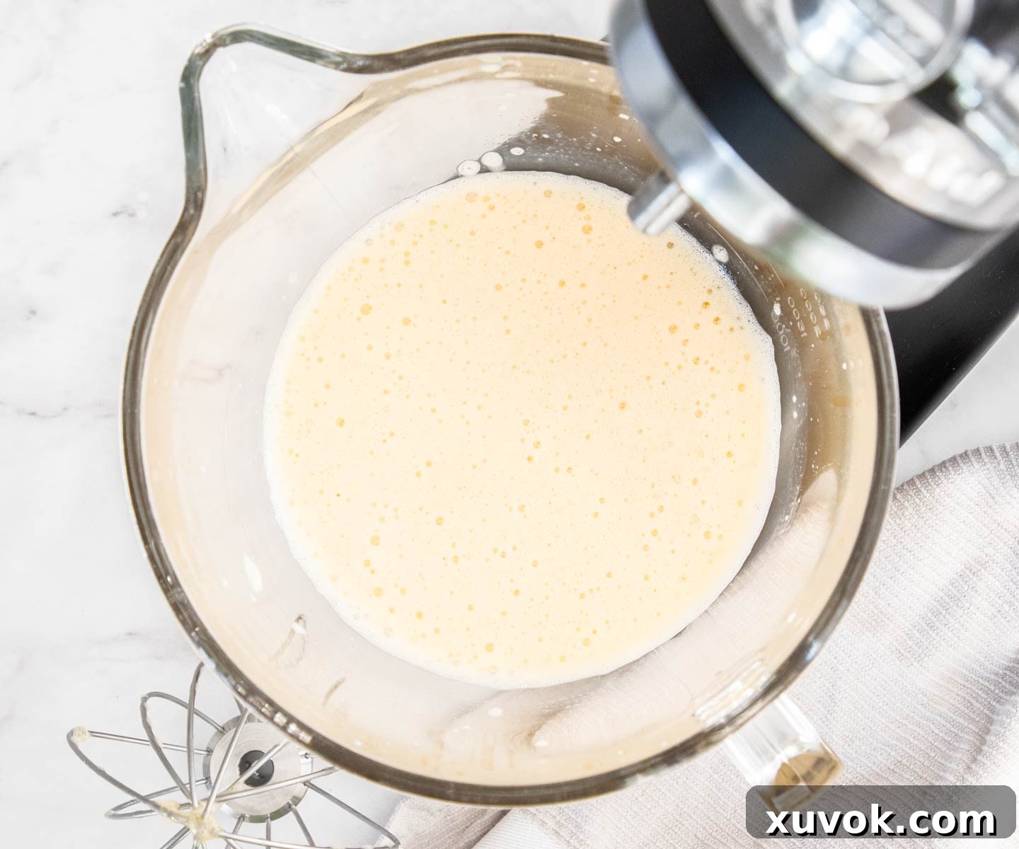 Egg mixture in a mixing bowl, beaten until frothy and light yellow.