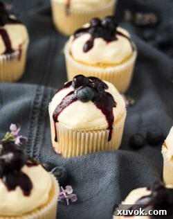 Fluffy and moist, Lemon Blueberry Cupcakes are filled with a surprise blueberry compote centre and a simple, creamy cream cheese frosting