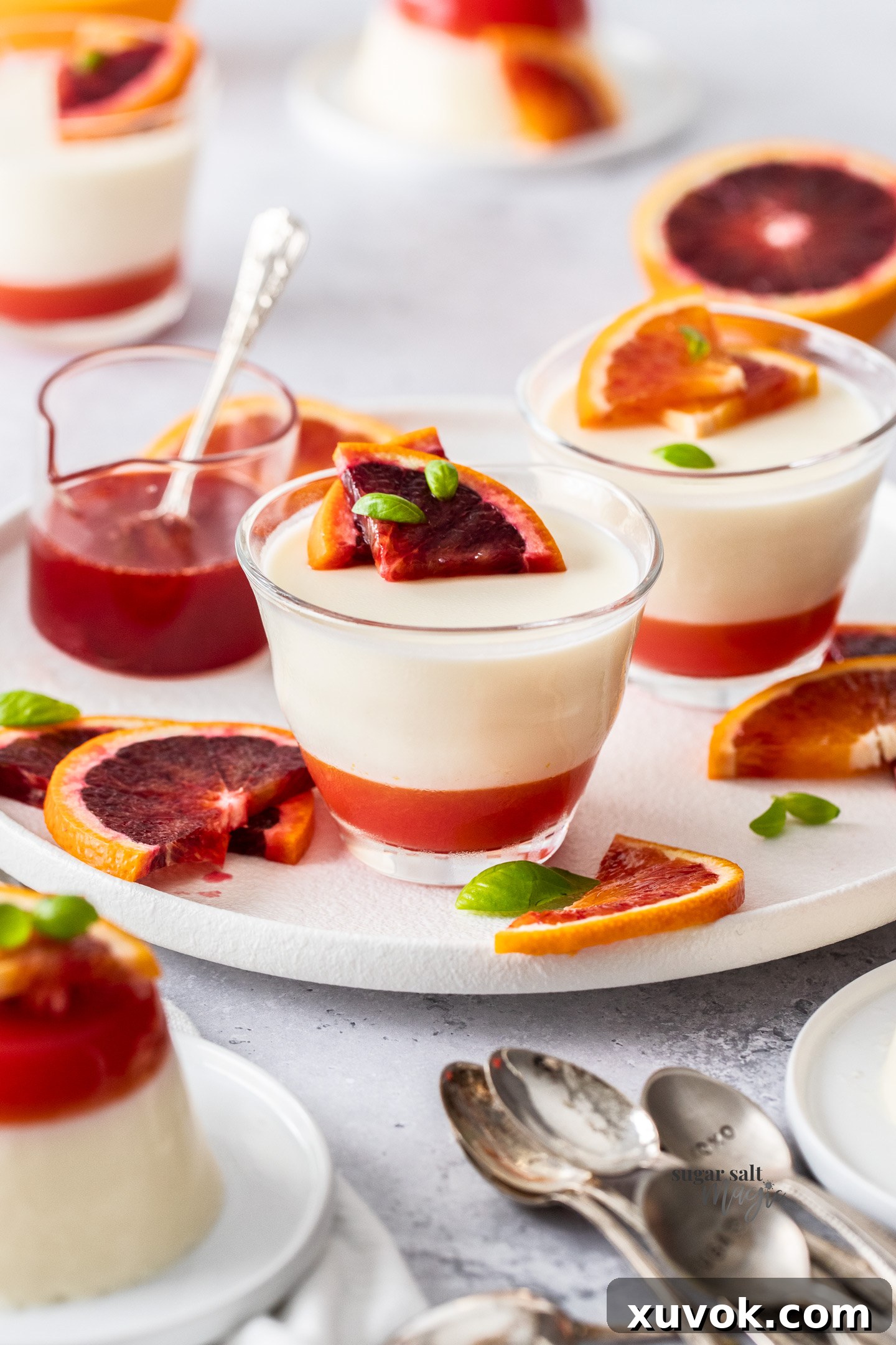 Buttermilk panna cotta with blood orange slices, on a platter.