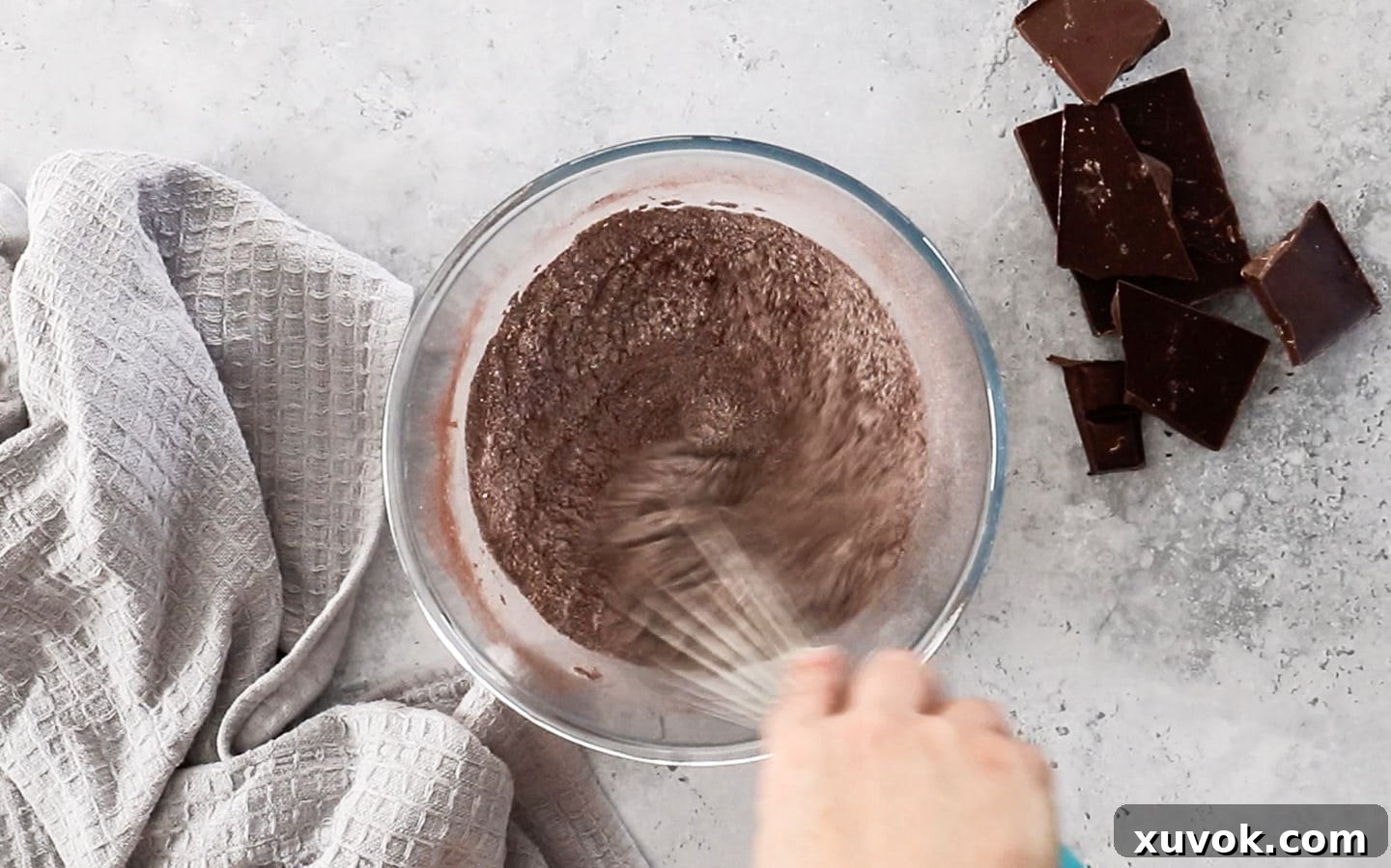 Mixing together flour, cocoa, baking powder, baking soda, and salt in a large bowl for the chocolate cupcake batter.