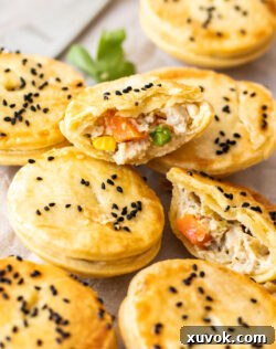 A mini chicken pot pie broken in half to show the filling.